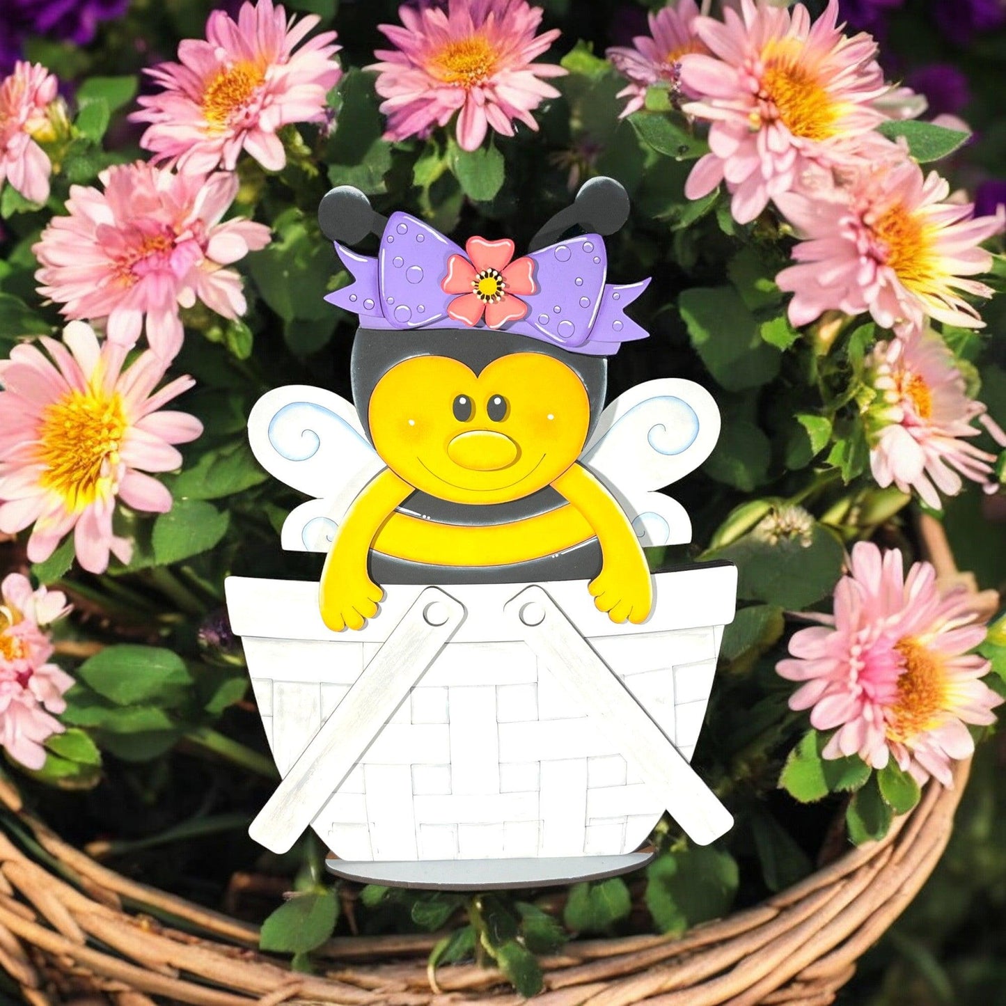 a paper cut out of a bee sitting in a basket of flowers