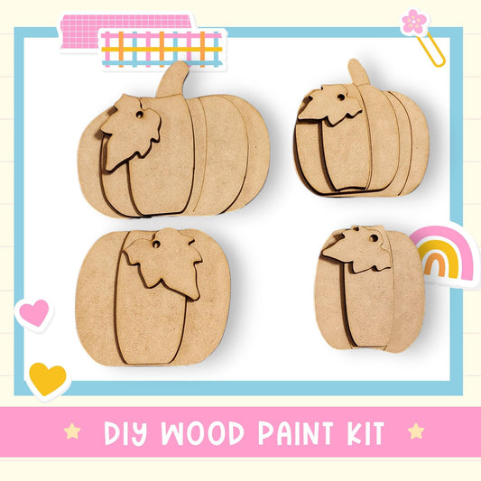 The image is a DIY wood paint kit featuring four wooden pumpkin shapes, each with a leaf attached, displayed on a white background.