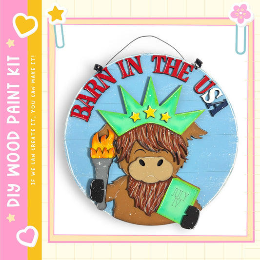 a wooden sign with a cartoon character holding a torch and a book, with the text "Barn in the USA" written on it.