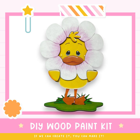 a DIY wood paint kit for creating a wooden flower. The kit includes a wooden flower with a yellow body and pink petals, as well as instructions for painting the flower.