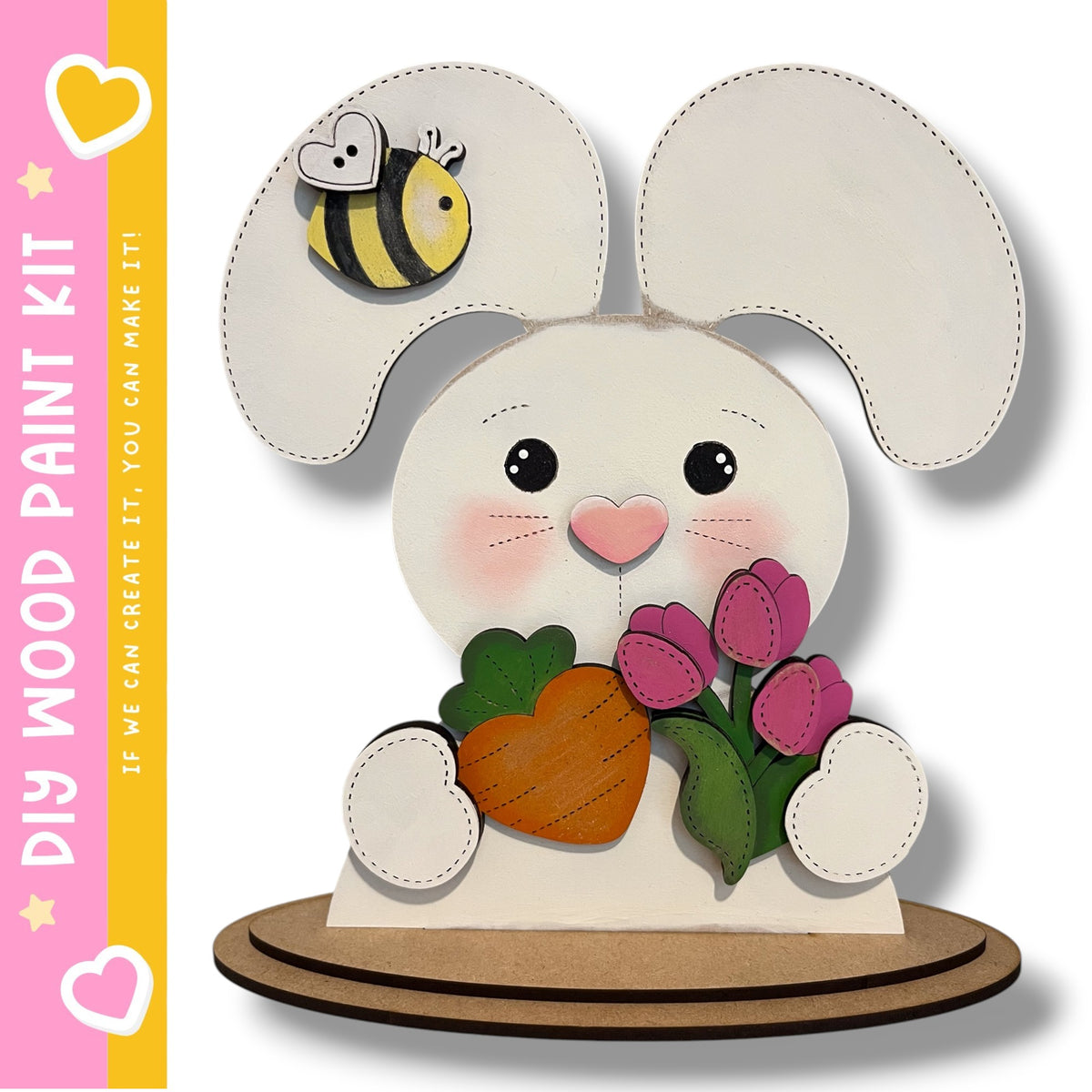 A wooden rabbit figurine holding a carrot and flowers, with a bee on its ear.