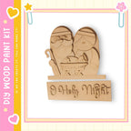 A wooden nativity scene depicting Santa Claus, Mary, and baby Jesus, with the phrase "Holly Night" written below.