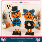 two wooden Halloween decorations, a jack-o-lantern and a ghost, standing on a wooden surface. The decorations are dressed in black and blue outfits, and they are surrounded by pumpkins and other Halloween-themed decorations.