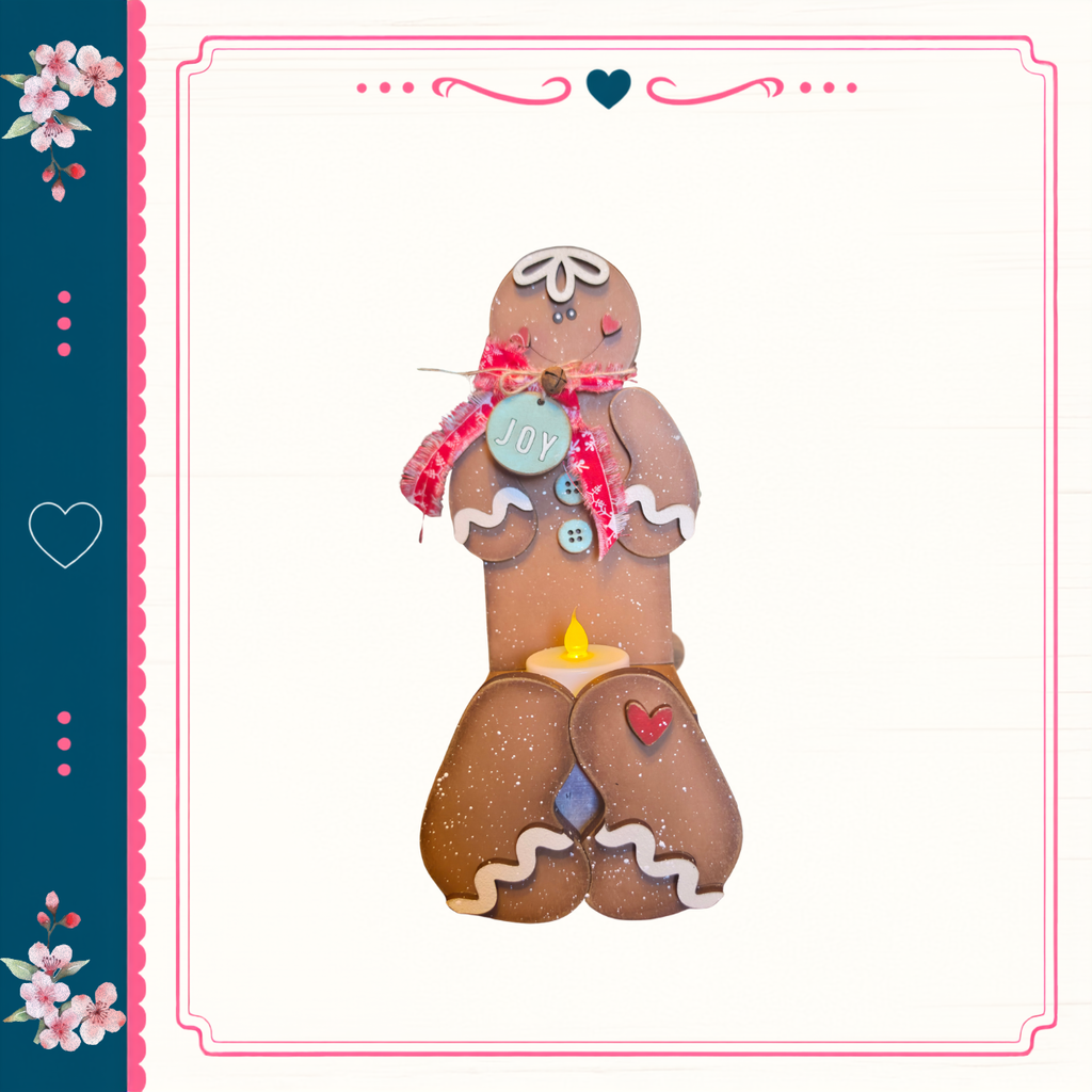 A gingerbread man figure with a "Joy" sign on its chest, standing on a white background with a decorative border.
