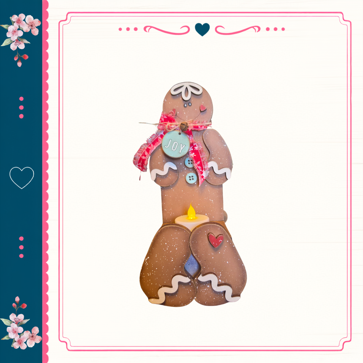 A gingerbread man figure with a "Joy" sign on its chest, standing on a white background with a decorative border.