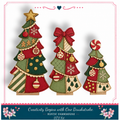three Christmas tree decorations made of fabric, each with different colors and patterns, arranged in a row.