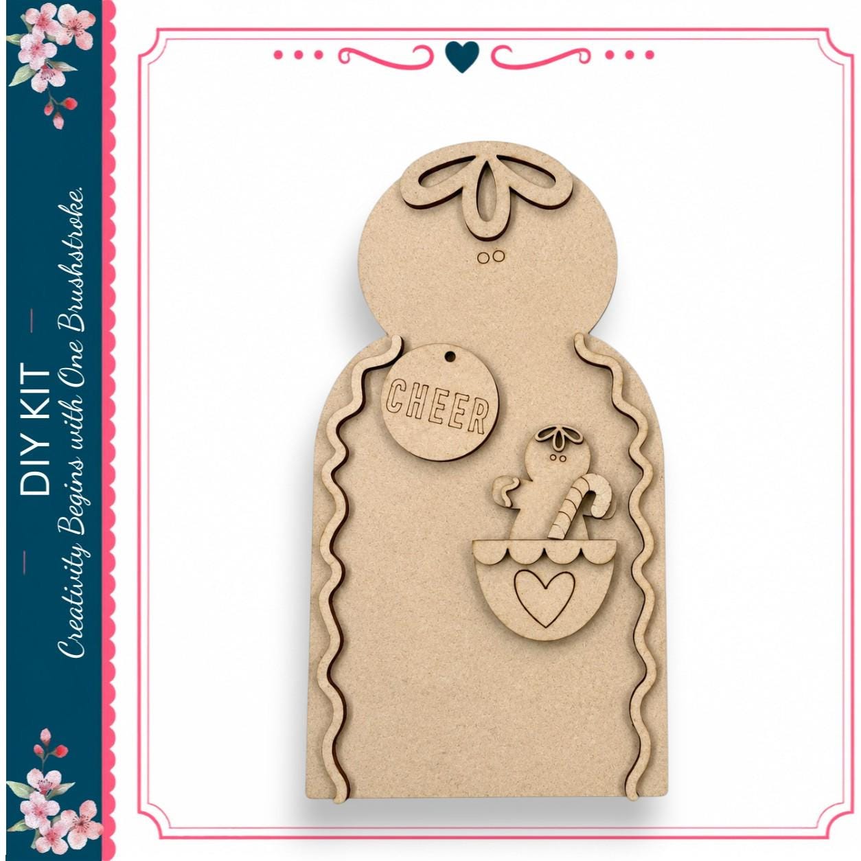 a wooden gingerbread house kit with a cheerful gingerbread man and a heart-shaped tag.