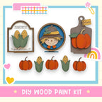 The image is a DIY wood paint kit featuring a farm fresh sign, a scarecrow, and several carved pumpkins.