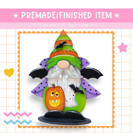 a paper craft of a halloween gnome with a pumpkin