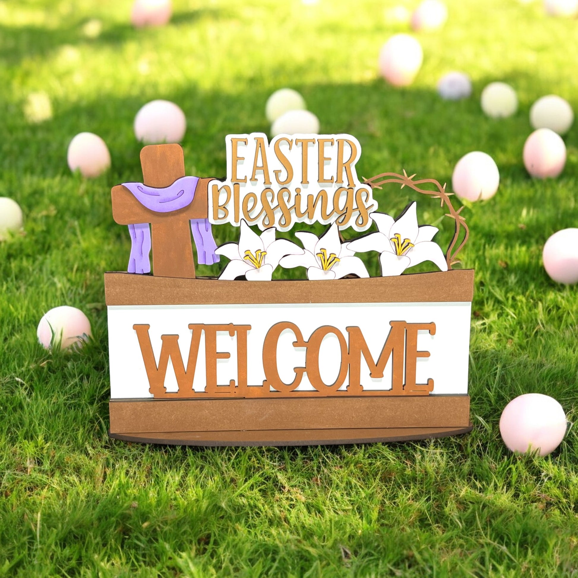 a wooden welcome sign sitting on top of a lush green field