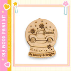 A wooden snow globe with a truck on top, surrounded by snowflakes, is displayed against a pink and yellow background.