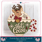 A wooden mug with a reindeer and snowflakes, along with the text "Hot Cocoa" written on it, is displayed in the image.
