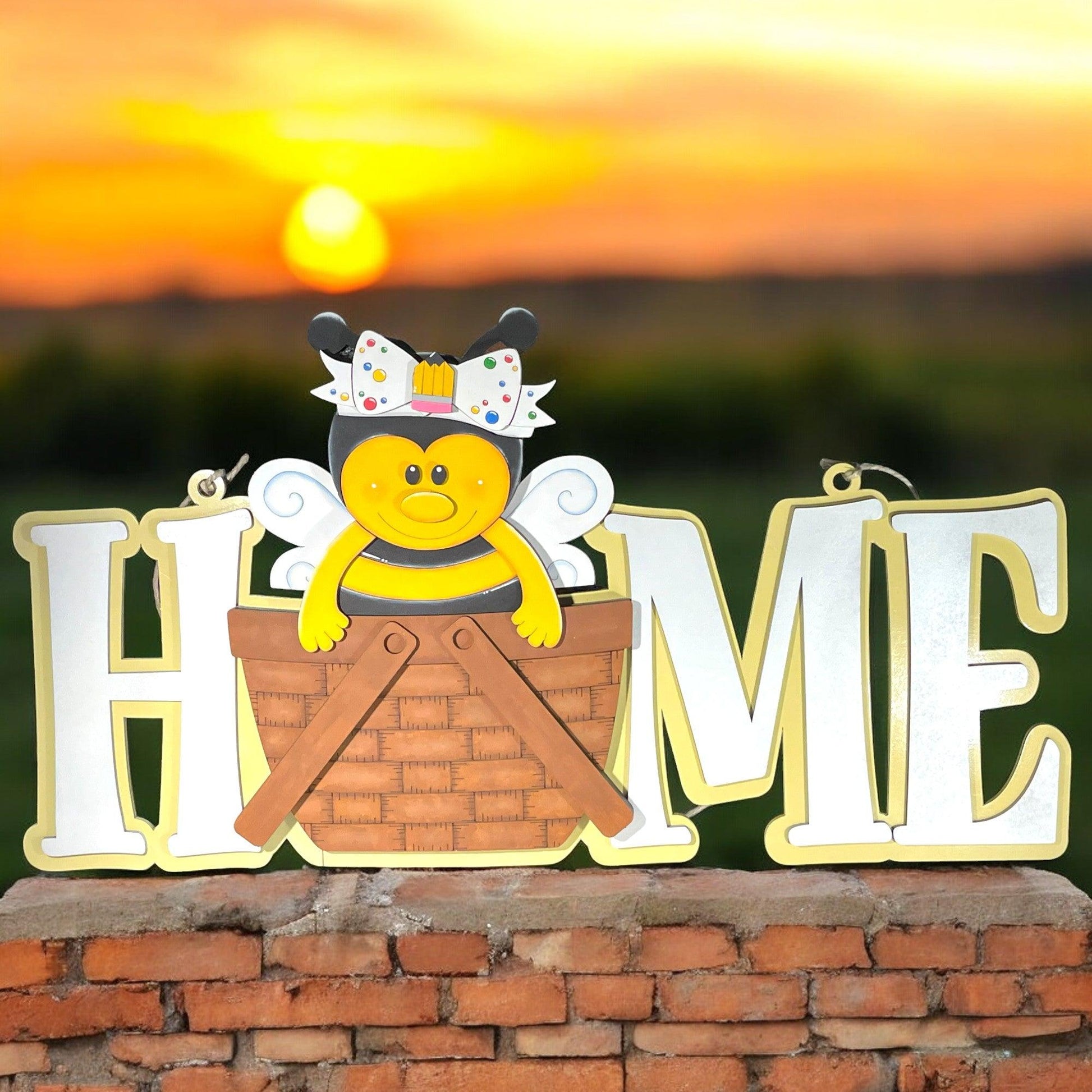 a sign that says home with a bee on it