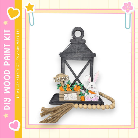 A wooden lantern with a bunny and carrots on a wooden tray, surrounded by a beaded garland.