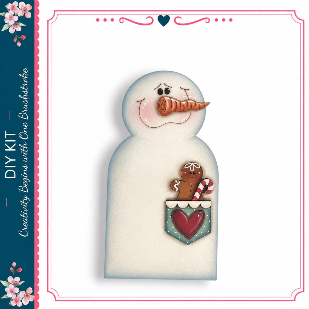 A snowman with a gingerbread man and a heart-shaped cookie in its pocket, set against a white background with a decorative border.