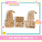 a DIY wood paint kit with two wooden elf figurines and a sign that reads "This house is under construction".