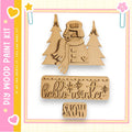 a DIY paint kit for creating a snowman, with a wooden snowman and a snowman-shaped cutout. The kit includes a snowman cutout and a snowman-shaped cutout, both made of wood. The kit also includes a wooden snowman cutout and a snowman-shaped cutout. The kit is designed for creating a winter scene with a snowman and a snowman.