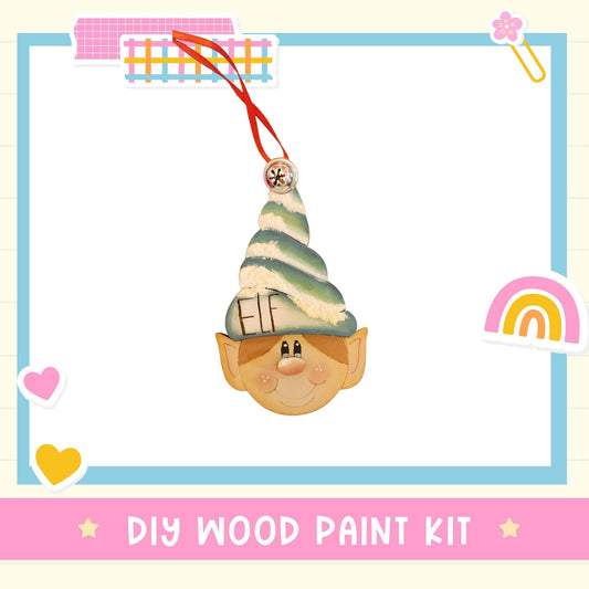 a DIY wood paint kit with a wooden elf head ornament, surrounded by various colorful stickers and a heart shape.