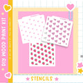The image is a colorful and playful advertisement for a DIY wood paint kit, featuring three stencil designs with hearts and strawberries on a pink background.