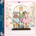 A wooden nutcracker figure holding a sword and a mouse figure, with a fairy figure in a pink dress, set against a snowy background with Christmas decorations.