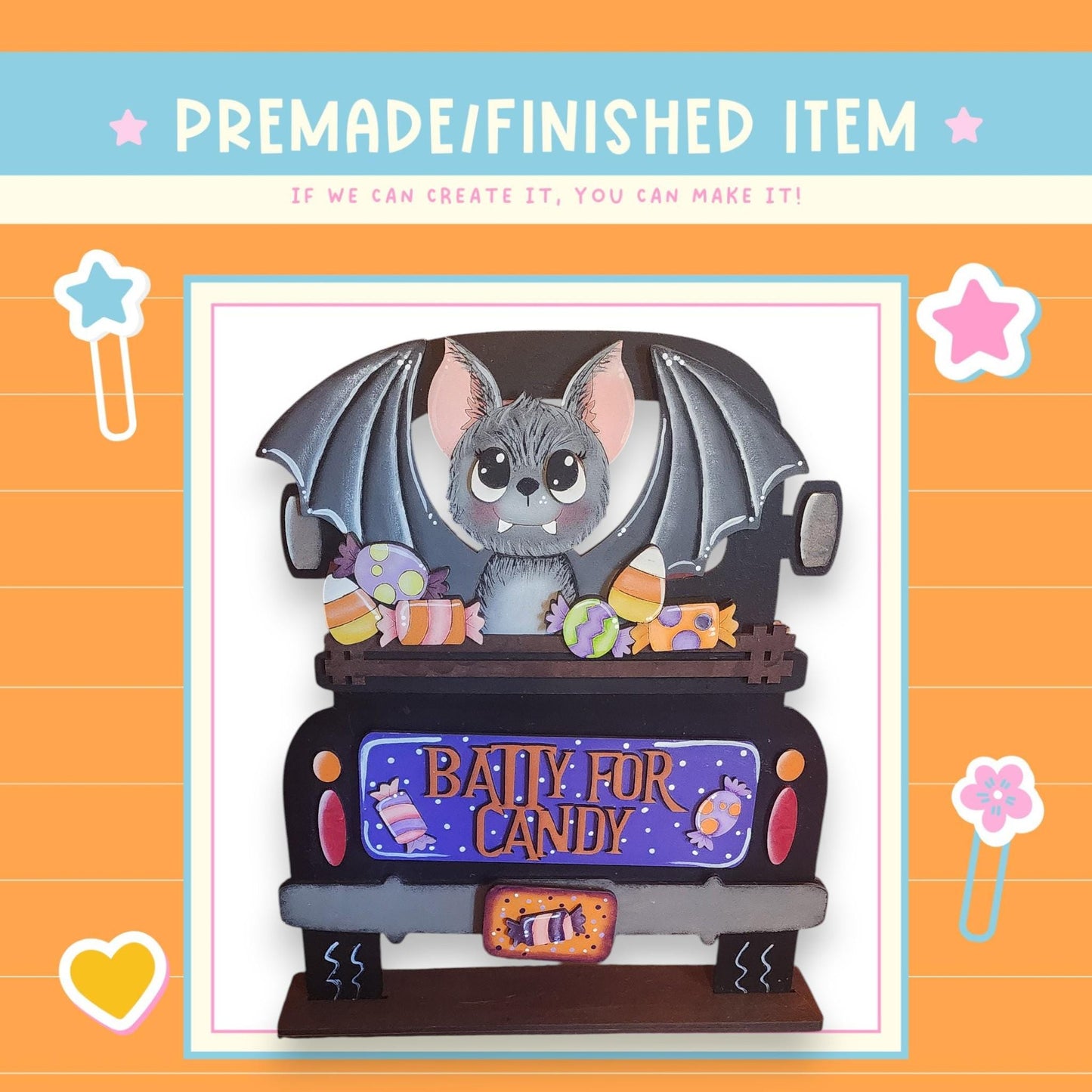 The image is a collage featuring a cartoon bat sitting in the back of a truck, surrounded by various Halloween-themed items such as candy and a star.