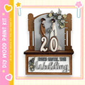 A wooden frame with a decorative border, displaying a couple standing together and the number 20. The frame also has text that reads "DAYS UNTIL THE WEDDING".