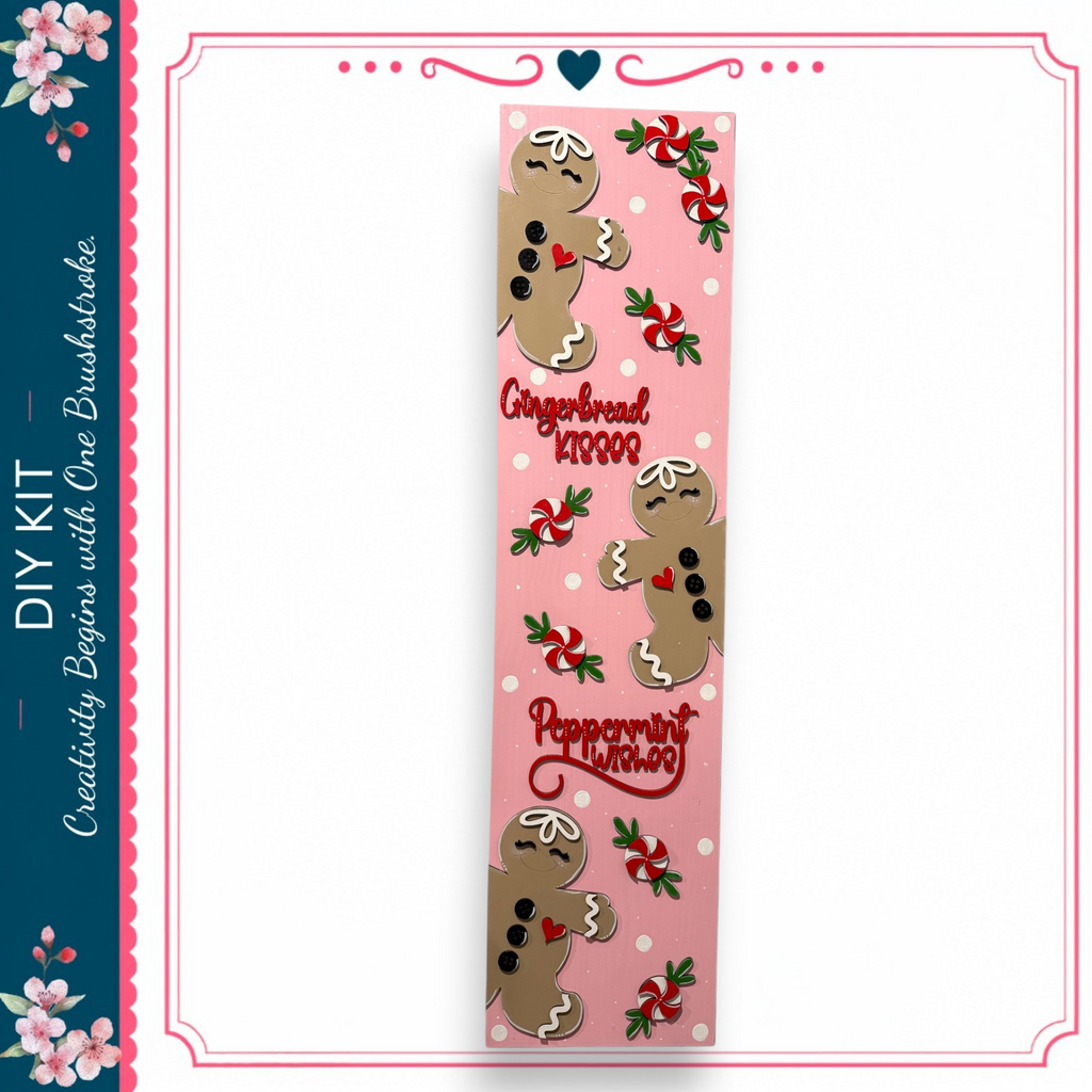 A pink bookmark with a gingerbread man design and peppermint candy decorations.