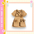 A wooden craft kit depicting a nurse's outfit with various tools and accessories, such as a stethoscope, scissors, and a heart.