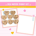 The image is a DIY wood paint kit advertisement featuring heart-shaped wooden charms and a blank white frame.