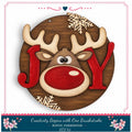 A wooden sign featuring a reindeer's face with the word "Joy" written in red letters, surrounded by snowflakes and flowers.