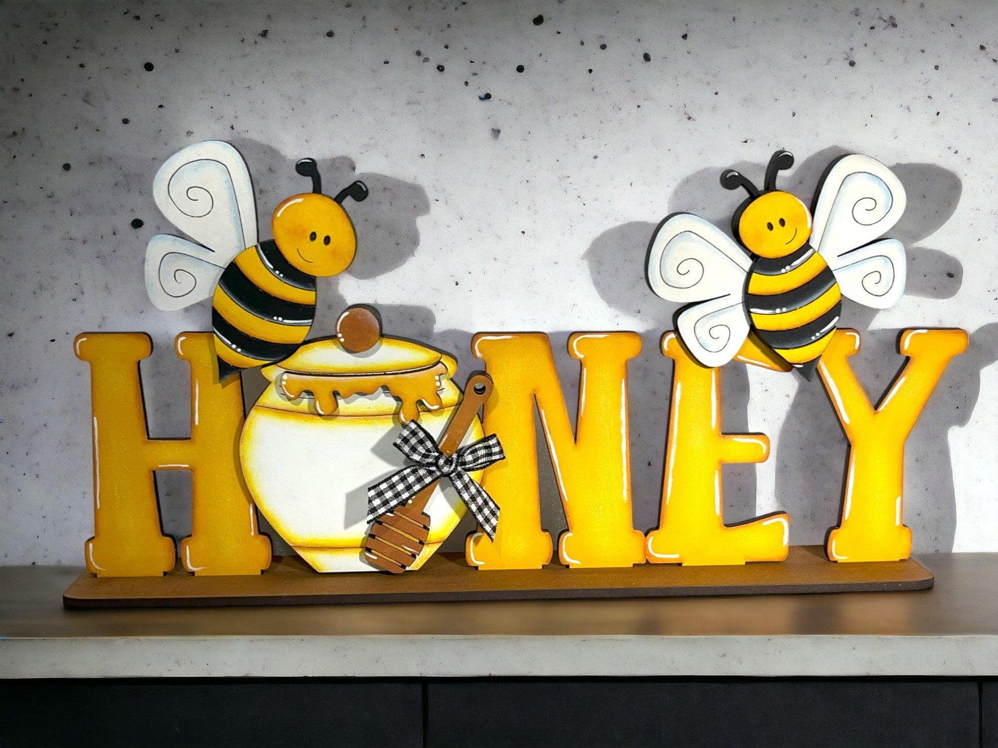 a wooden sign that says honey with two bees on it