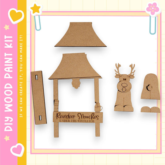 a DIY paint kit for creating a Christmas tree, including a wooden reindeer and other Christmas-themed elements.