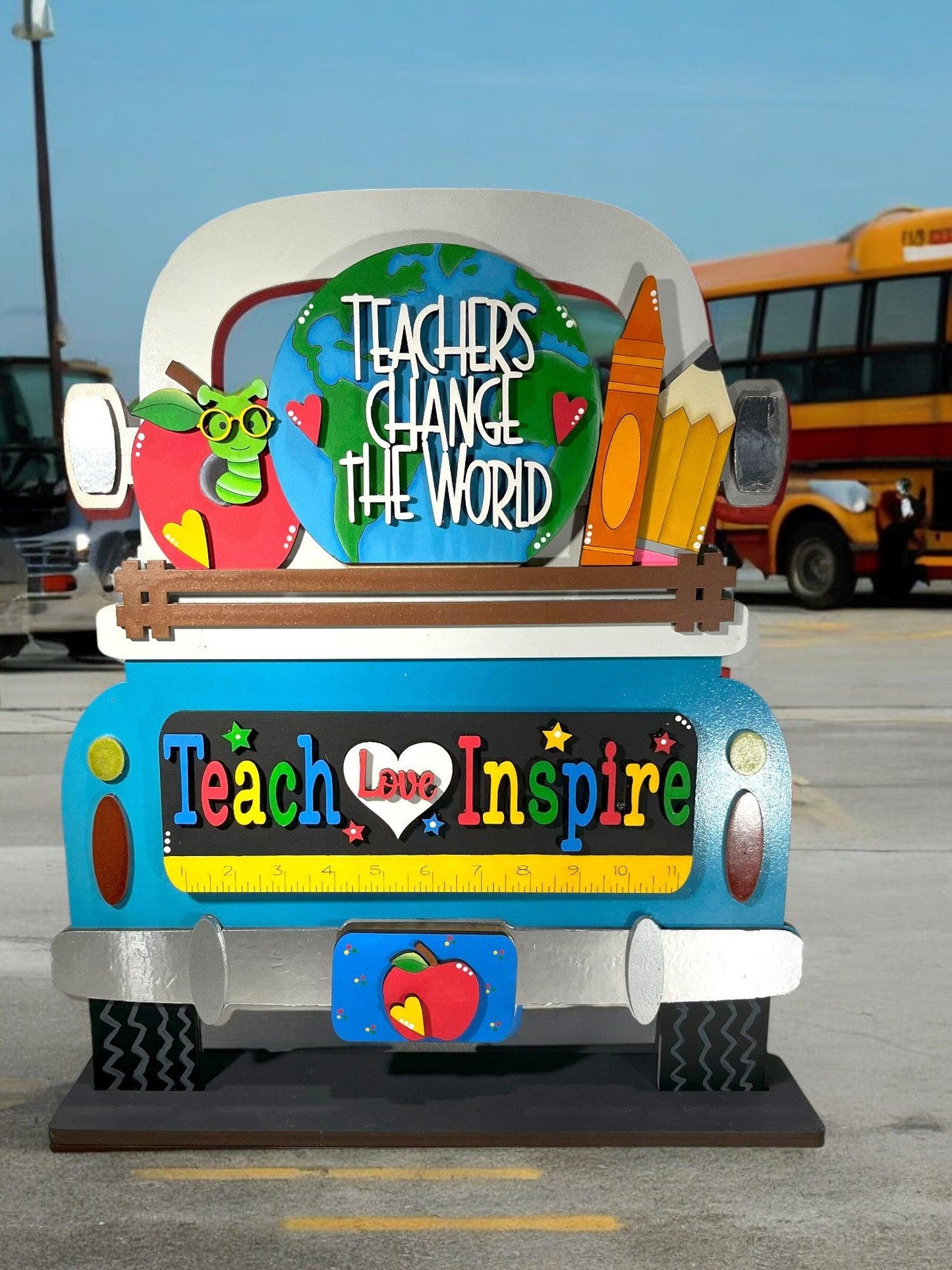 a school bus with a sign that says teachers change the world