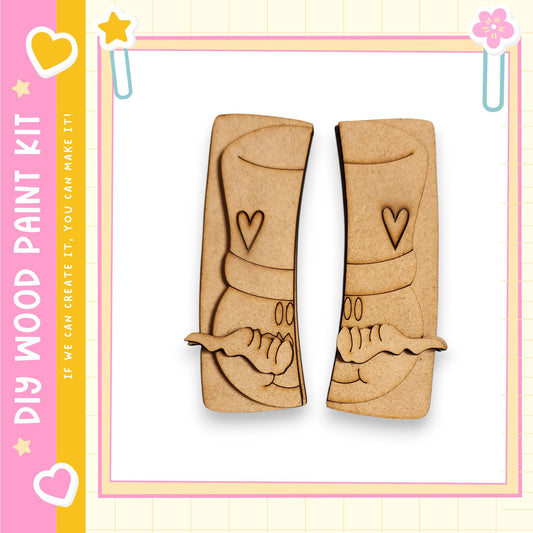 two wooden cutouts of a smiling face, each with a heart and a star, set against a pink and yellow background.