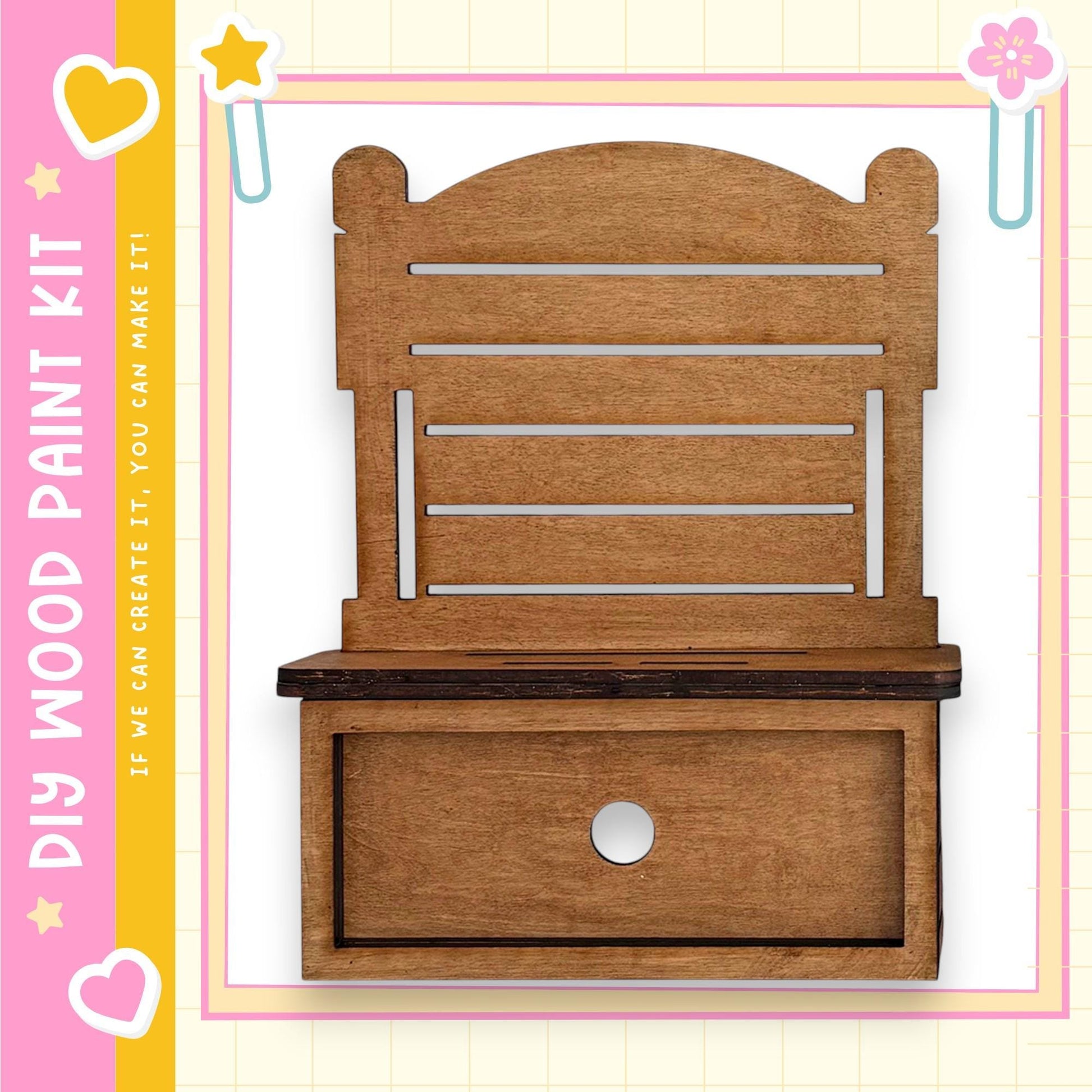 a wooden shelf with a drawer, set against a pink and yellow background with decorative elements.