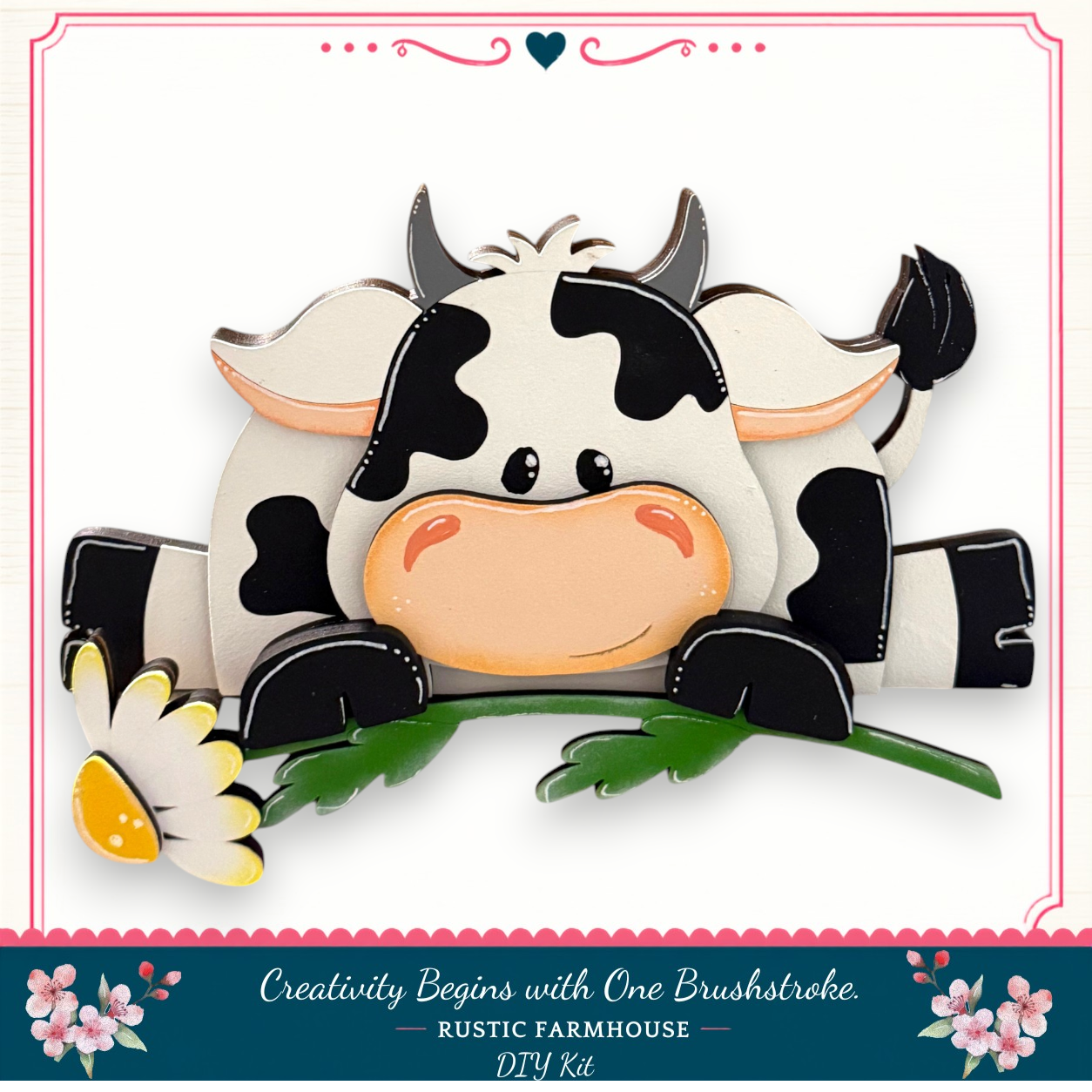 A wooden cow figurine with a flower in its mouth, sitting on a green leaf.