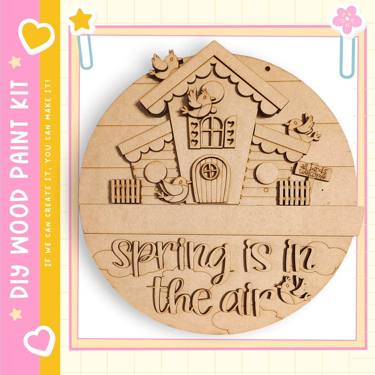 A wooden sign with a house and birds on it, along with the text "Spring is in the air"