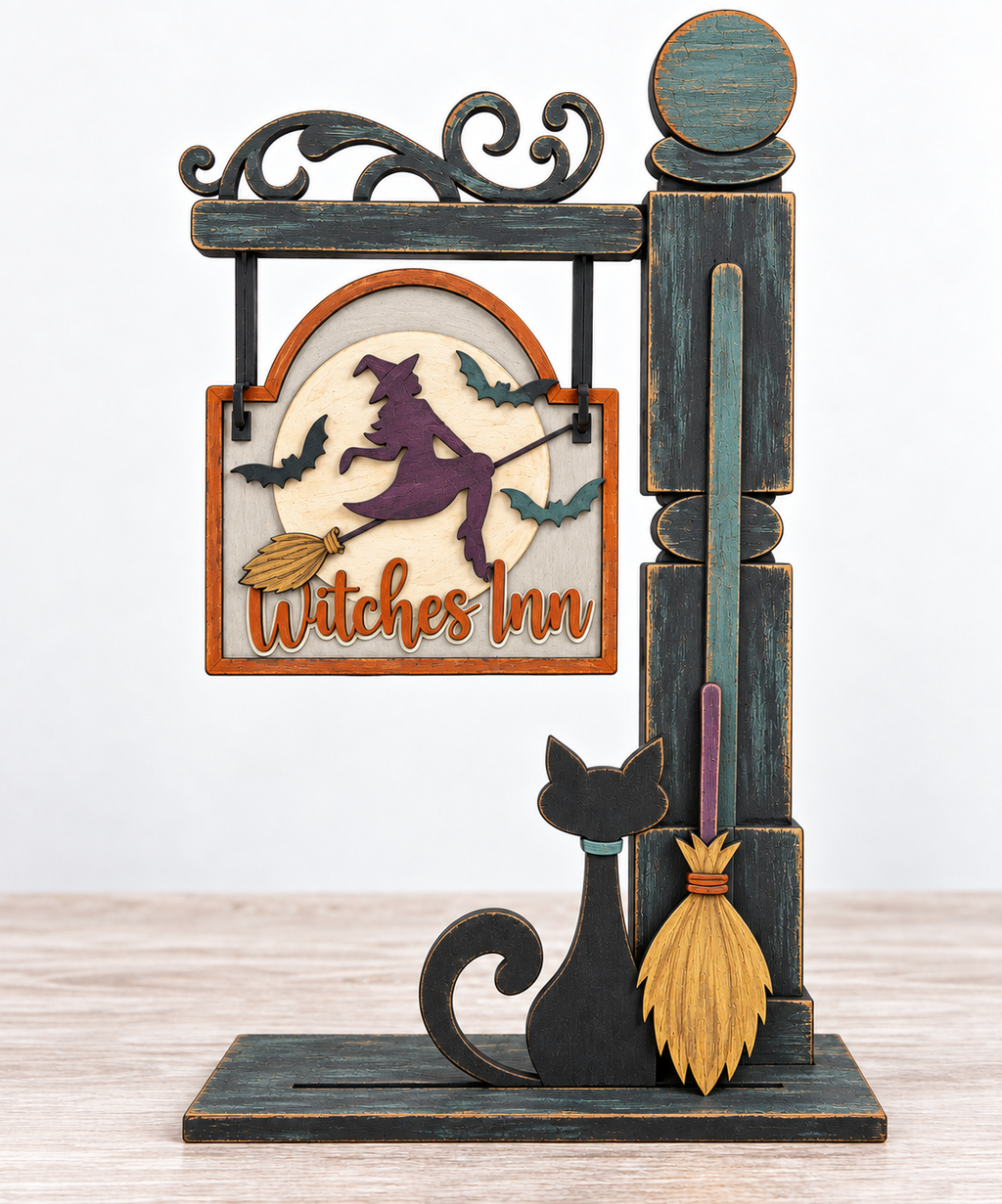 A wooden sign with a witch on a broomstick, accompanied by a cat and a broom, is displayed on a wooden stand.