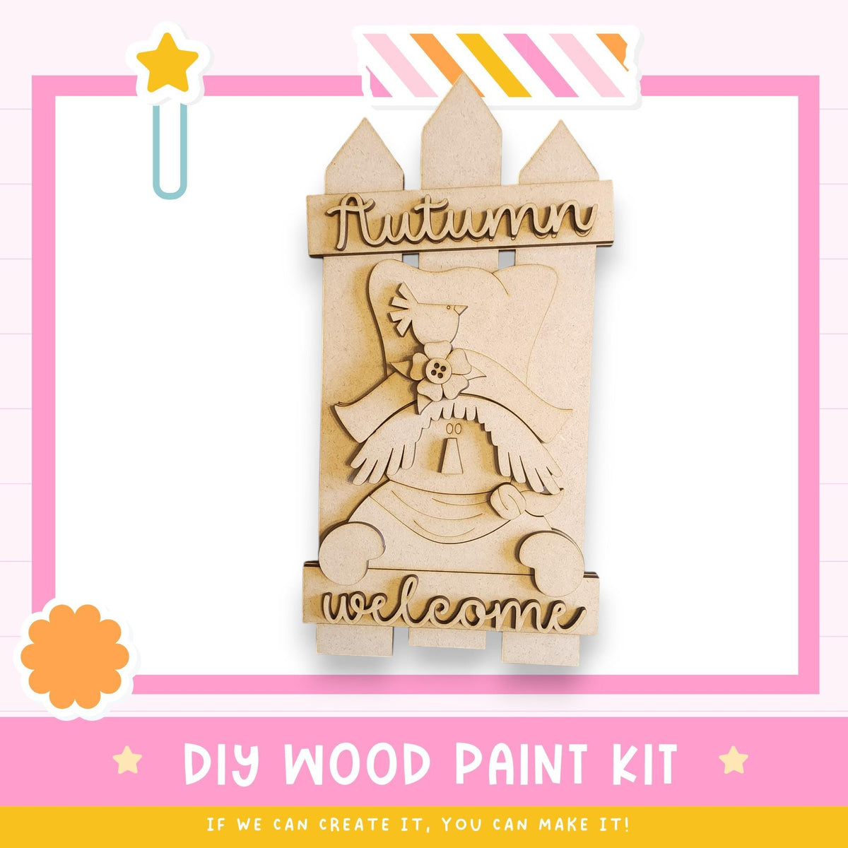 a DIY wood paint kit for creating a welcome sign. The kit includes a wooden sign with a bird and the text "Autumn welcome" written on it. The kit is presented in a pink and white frame, and there is a star decoration on the left side of the frame.