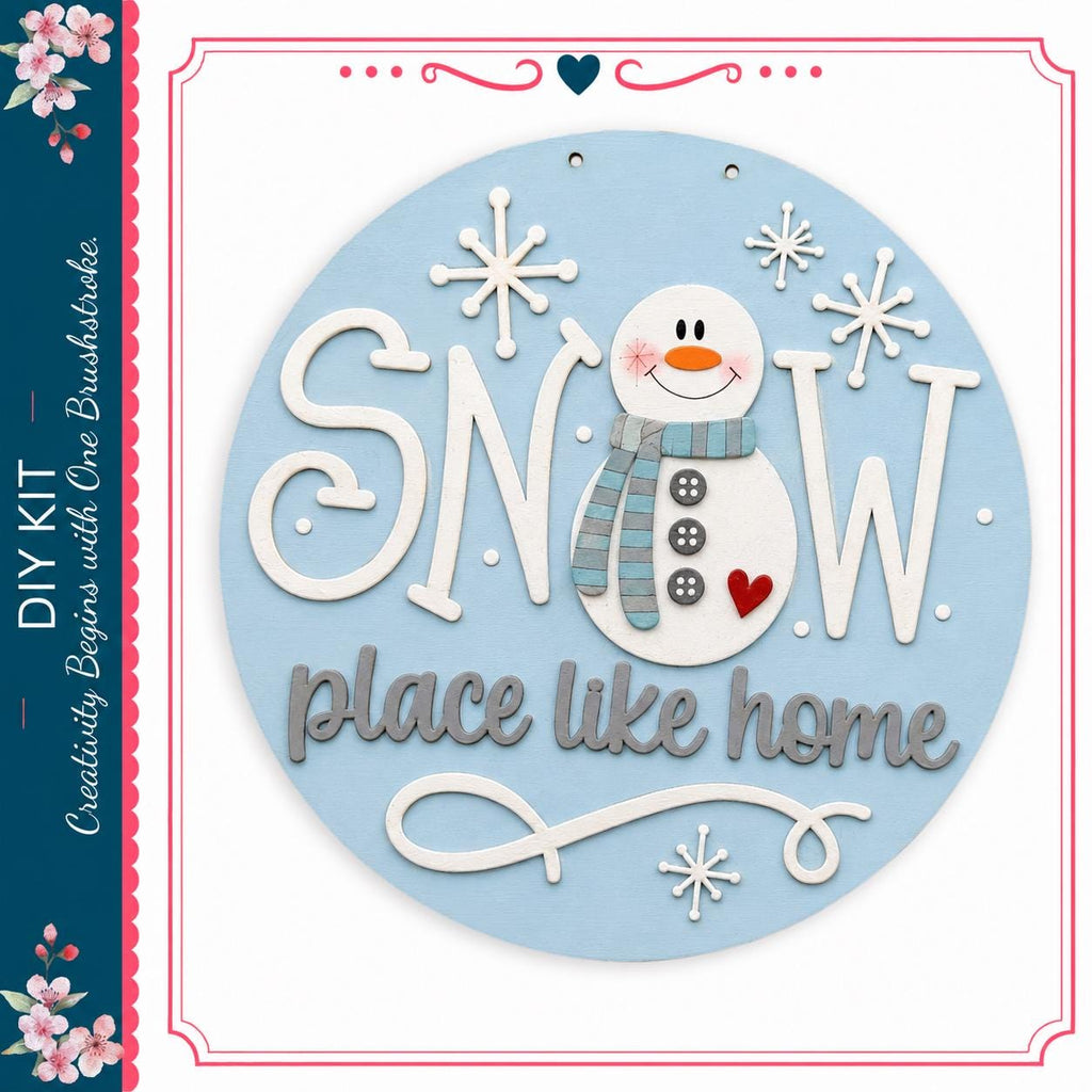 A snowman decoration with the text "SNOW place like home" and snowflakes surrounding it.