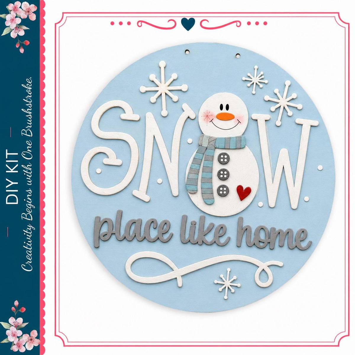A snowman decoration with the text "SNOW place like home" and snowflakes surrounding it.