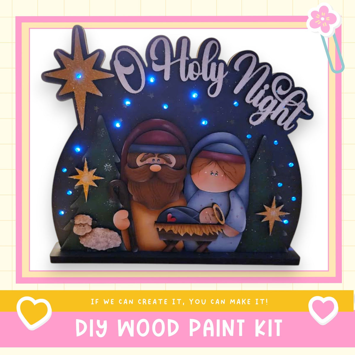 A DIY wood paint kit for creating a nativity scene with a wooden figure of the baby Jesus, Mary, and Joseph, surrounded by stars and other holiday decorations.