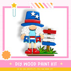 A DIY wood paint kit for creating a wooden gnome figure, with a signpost indicating a "Fireworks Carnival Barbecue" event.