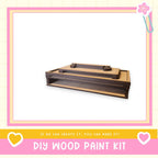 a DIY wood paint kit, with a wooden box and a wooden shelf visible.