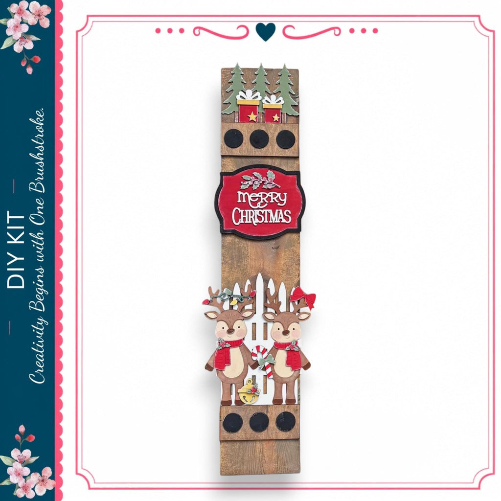 A wooden Christmas decoration with two reindeer and a "Merry Christmas" sign.
