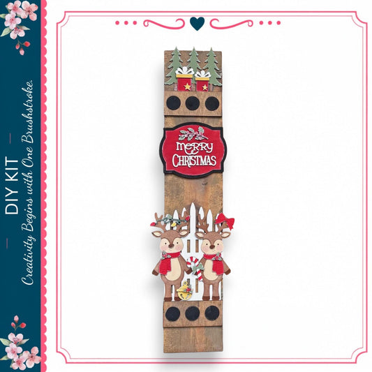 A wooden Christmas decoration with two reindeer and a "Merry Christmas" sign.