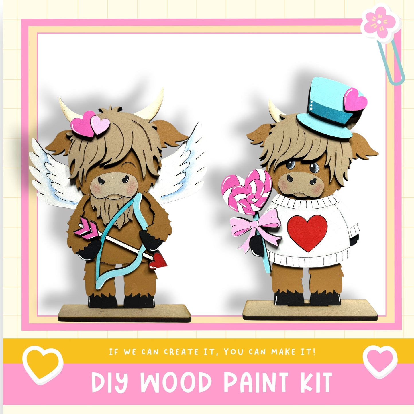 two wooden figurines, one with wings and the other with a heart-shaped hat, both holding candy hearts and bows, set against a pink and white background.