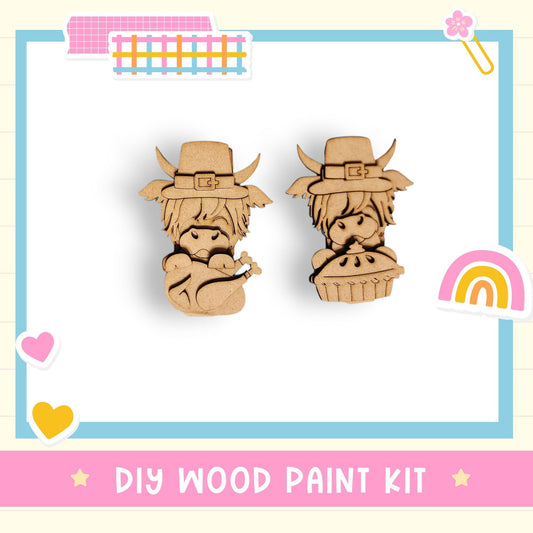 two wooden cutouts of cartoon-like characters wearing hats, likely representing a DIY wood paint kit for creating wooden figures.