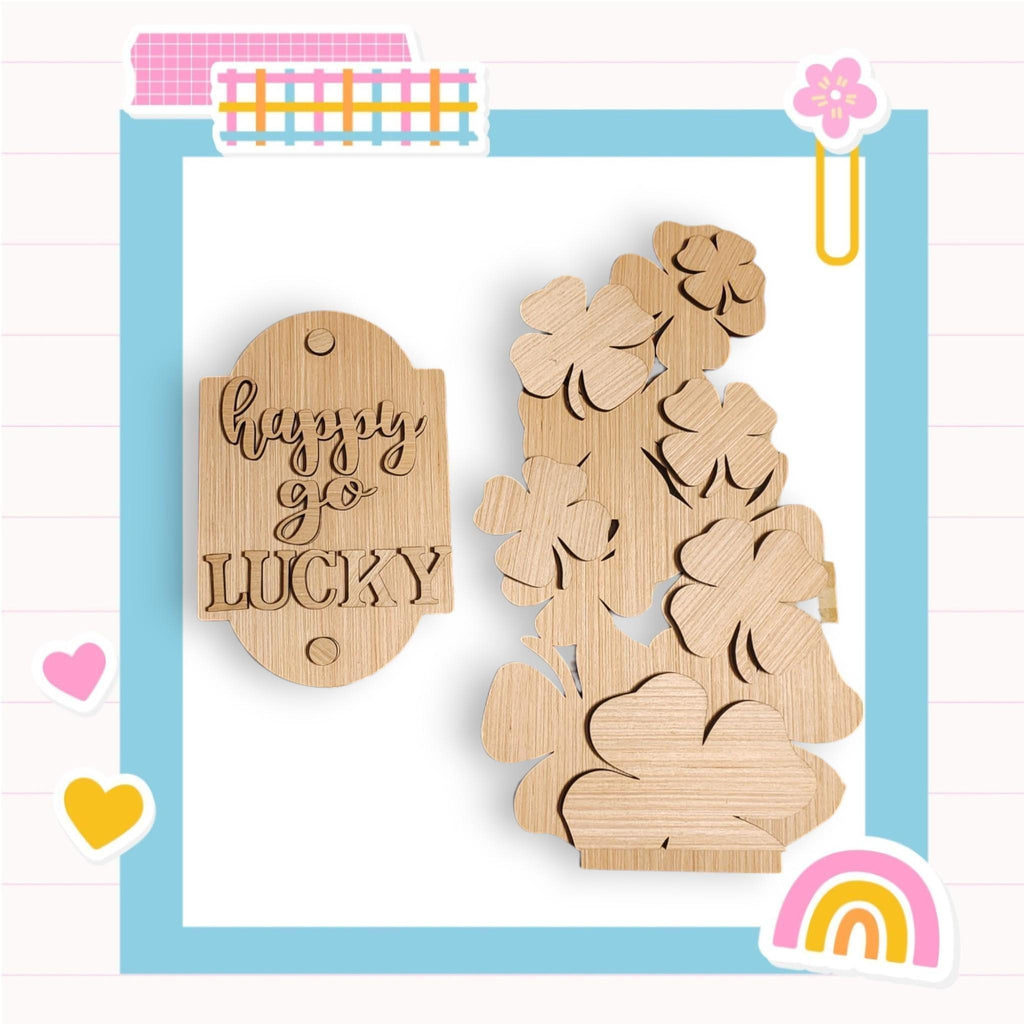 a wooden cutout of a teddy bear with a rainbow in the background