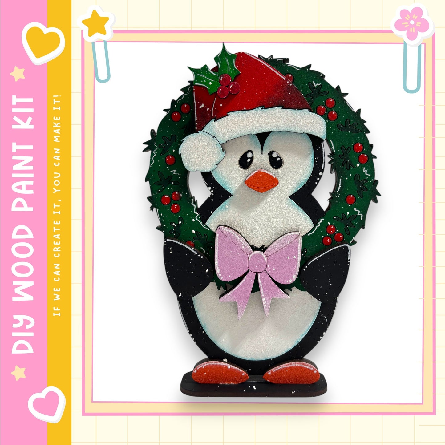 A wooden penguin wearing a Santa hat and holding a bow, standing in front of a wreath.